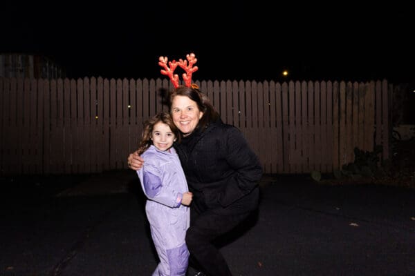 Spartan Waste team member smiling with a child at the Spartanburg Christmas Parade.
